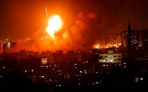  A fireball explodes during Israeli air strikes in Gaza City - Credit: AFP