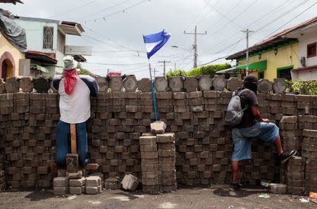 A demonstrator stands behind a barricade in the indigenous community of Monimbo in Masaya, July 6. REUTERS/Oswaldo Rivas