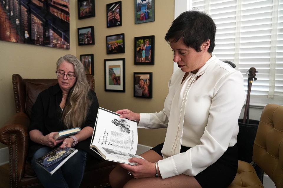 Iris Halpern, right, an attorney and partner at Denver-based firm Rathod Mohamedbhai, looks through one of the books removed from the Kingsland Public Library in Llano County, where her client, Suzette Baker, left, was the head librarian before being fired in 2022.
