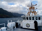 In this photo released by the U.S. Coast Guard, Coast Guard Cutter William Hart moves toward the Na Pali Coast on the Hawaiian island of Kauai on Friday, Dec. 27, 2019, the day after a tour helicopter disappeared with seven people aboard. Authorities say wreckage of the helicopter has been found in a mountainous area on the island. (Lt. j.g. Daniel Winter/U.S. Coast Guard via AP)