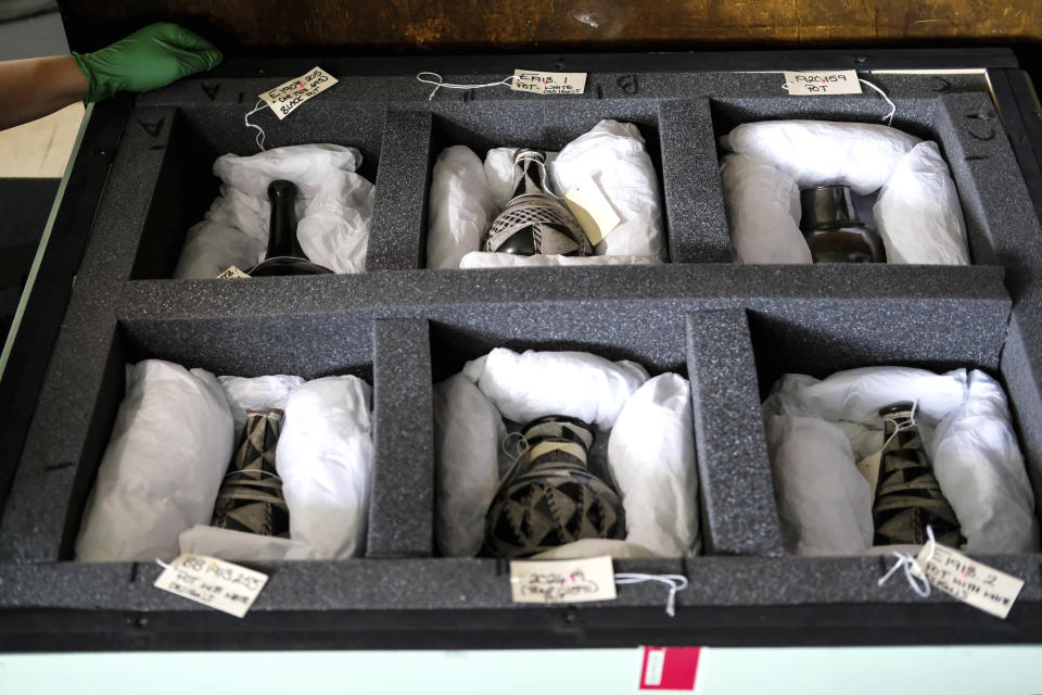 Traditional artifacts repatriated by the University of Cambridge, shown exclusively to AP journalists, sit in a box in Kampala, Uganda, Wednesday, June 12, 2024. The British university returned the 39 items, which range from tribal regalia to delicate pottery, to the East African country on Saturday. (AP Photo/Hajarah Nalwadda)