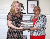 Singer-songwriter Madonna Ciccone (L) poses for a photograph with Kenyan First Lady Margaret Kenyatta as she receives a "Beyond Zero" campaign technical report at State House in Nairobi, Kenya, July 4, 2016. REUTERS/Presidential Press Service/Handout via REUTERS