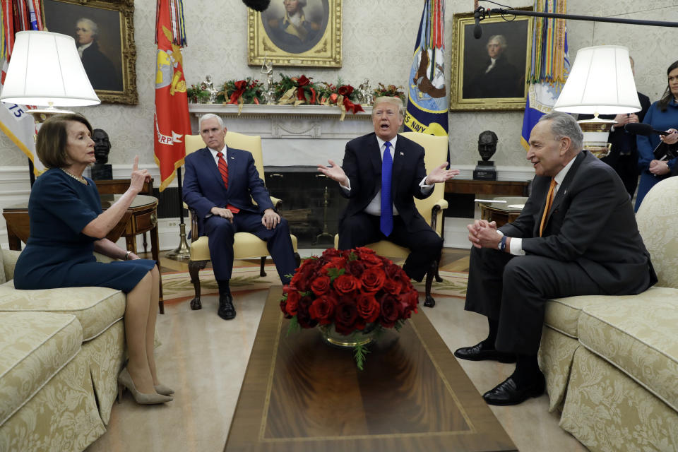 In this Dec. 11, 2018, photo, President Donald Trump and Vice President Mike Pence meet with Senate Minority Leader Chuck Schumer, D-N.Y., and House Minority Leader Nancy Pelosi, D-Calif., in the Oval Office of the White House in Washington. Congress is racing to avoid a partial government shutdown over President Donald Trump’s border. But you wouldn’t know it by the schedule. Lawmakers are away until next week. The ball is in Trump’s court, both sides say.  (AP Photo/Evan Vucci)