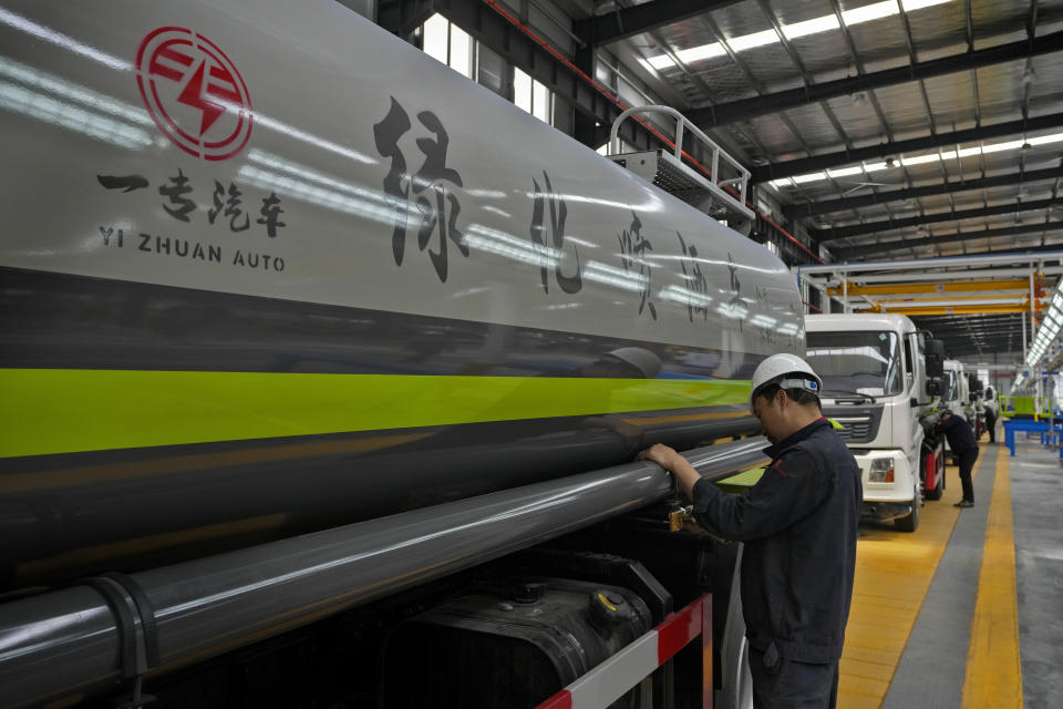 Workers assemble liquid tanker trucks at a Yizhuan Automobile Co. manufacturing factory during a media-organized tour in Shiyan city in central China's Hubei Province on May 12, 2023. China's manufacturing and consumer spending are weakening after a strong start to 2023 after anti-virus controls ended. (AP Photo/Andy Wong)