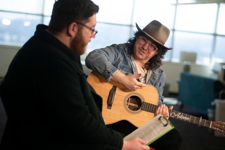 Knoxville singer-songwriter Adeem the Artist, right, joins downtown reporter Ryan Wilusz of Knox News during an episode of "The Scruffy Stuff" podcast at the Knox News office Jan. 4. Adeem has received critical acclaim for their Dec. 2 release of "White Trash Revelry," an album whose songs "Carolina," "For Judas" and "Middle of a Heart" were performed on the podcast episode, available now on Spotify, Apple and other streaming platforms.