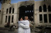 Palestinians reacts in front of a mosque which witnesses said was hit in an Israeli air strike, in Gaza City July 29, 2014. REUTERS/Suhaib Salem