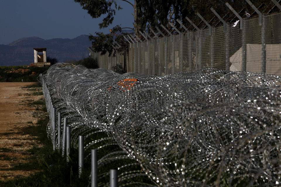 Barbed-wires surrounded a refugee camp in Kokkinotrimithia outside of capital Nicosia, Cyprus, Friday, Feb. 5, 2021. Cyprus' Interior Minister Nicos Nouris said this week that the east Mediterranean island nation whose closest point to Syria is around 150 kilometers (93 miles) remains first among all other European Union member states with the most asylum applications relative to its population. Last year, the country of around 1.1 million people racked up 7,000 asylum applications - most of them from Syrians. (AP Photo/Petros Karadjias)