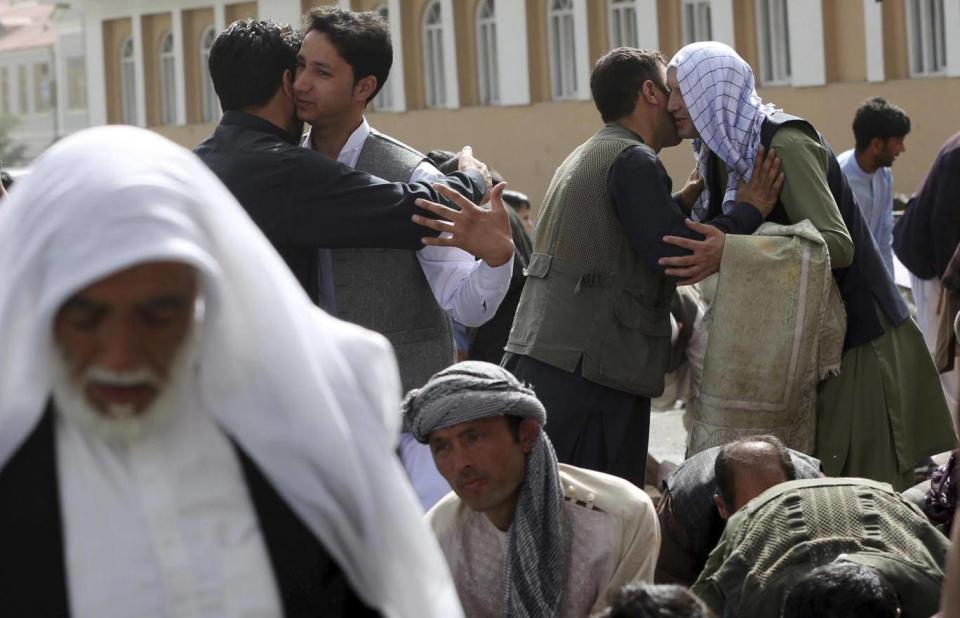 Men hug each other after Eid al-Fitr prayers outside of Shah-e-Dushamshera mosque in Kabul, Afghanistan on Friday (AP Photo/Massoud Hossaini)