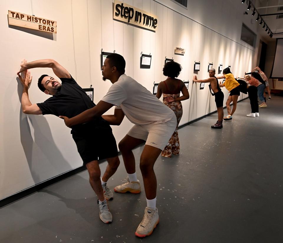 Solomon Steen, left, of Worcester, gets help from London Fleur De Lis as he and the rest of a vogue class learn to spin while using a wall as support at the Jean McDonough Arts Center in Worcester.