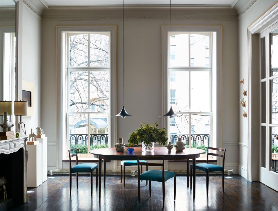 With his apartment's high ceilings and relatively large rooms in NYC's Chelsea neighborhood, Argentinian-born architect and interior designer turned ceramist Carlos Otero describes it as “perfect to entertain in.” The vintage Danish rosewood table is designed by Niels Moller, as are the teak dining chairs, which are covered in a blue velvet from Schumacher. When you buy something through a retail link on Architectural Digest, we may earn an affiliate commission.