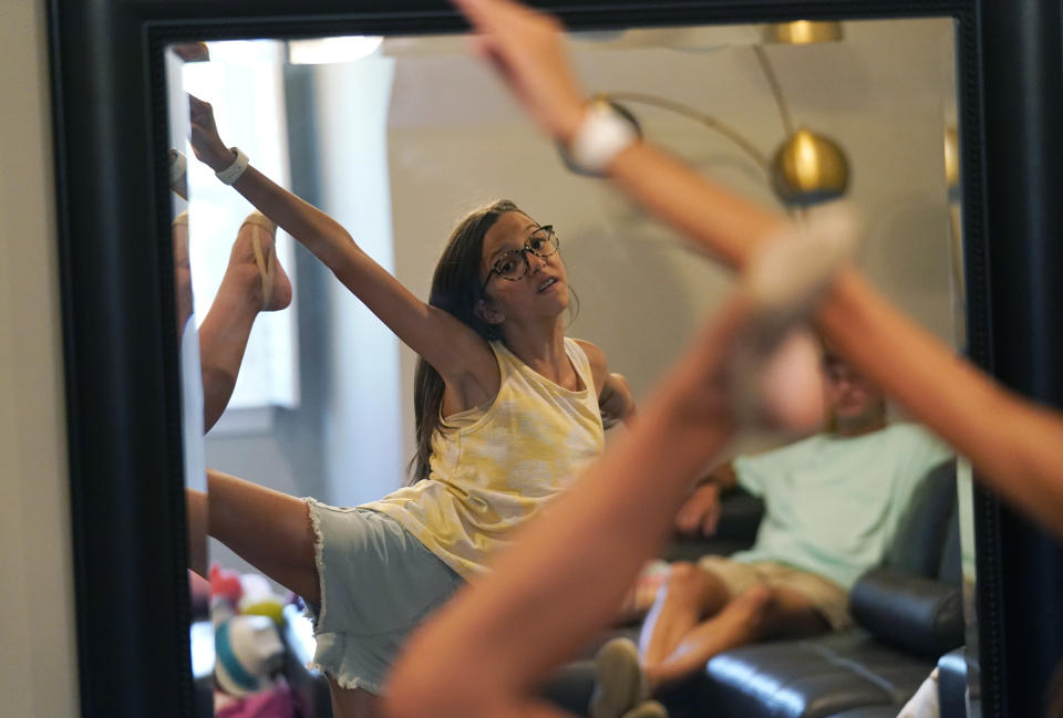 Cecilia Shaffette practices her dance routine in front of her father Rhett Shaffette at their home in Carriere, Miss., Wednesday, June 16, 2021. (AP Photo/Gerald Herbert)