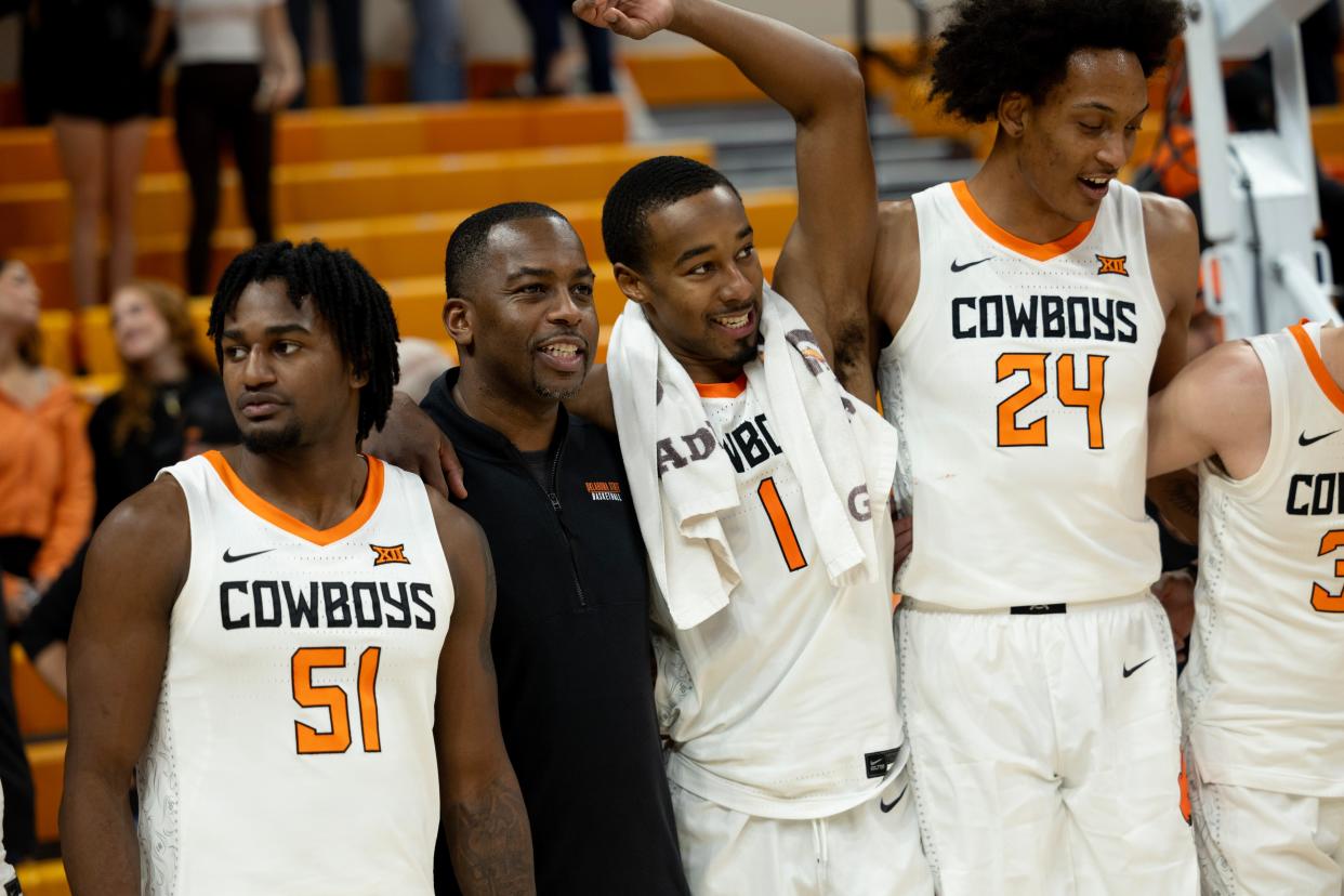 OSU coach Mike Boynton celebrates with John-Michael Wright (51), Bryce Thompson (1) and Isaiah Miranda (24) after beating Oral Roberts on Dec. 17 at Gallagher-Iba Arena in Stillwater.