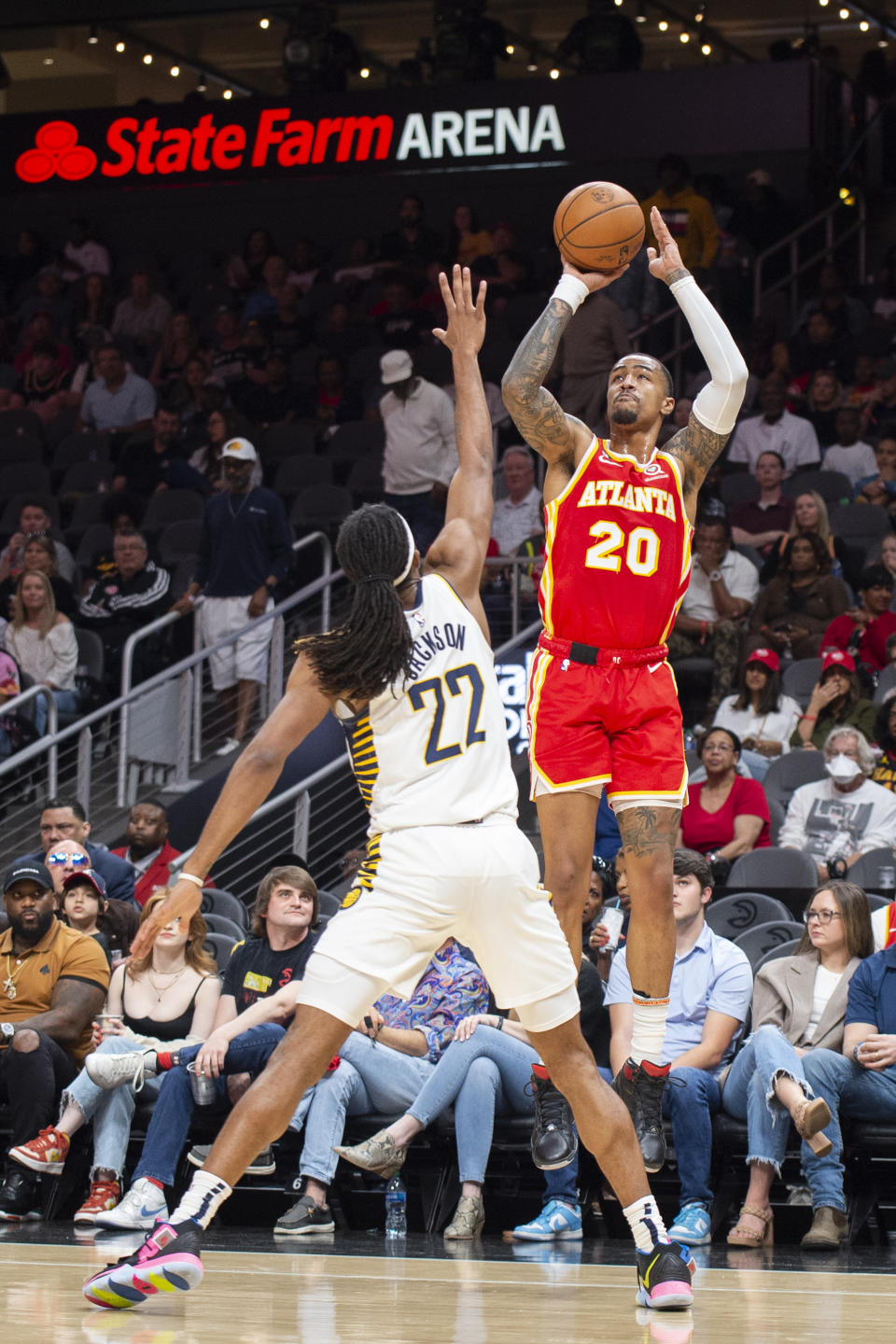 Atlanta Hawks forward John Collins shoots a 3-pointer over Indiana Pacers forward Isaiah Jackson during the first half of an NBA basketball game, Saturday, March 25, 2023, in Atlanta. (AP Photo/Hakim Wright Sr.)