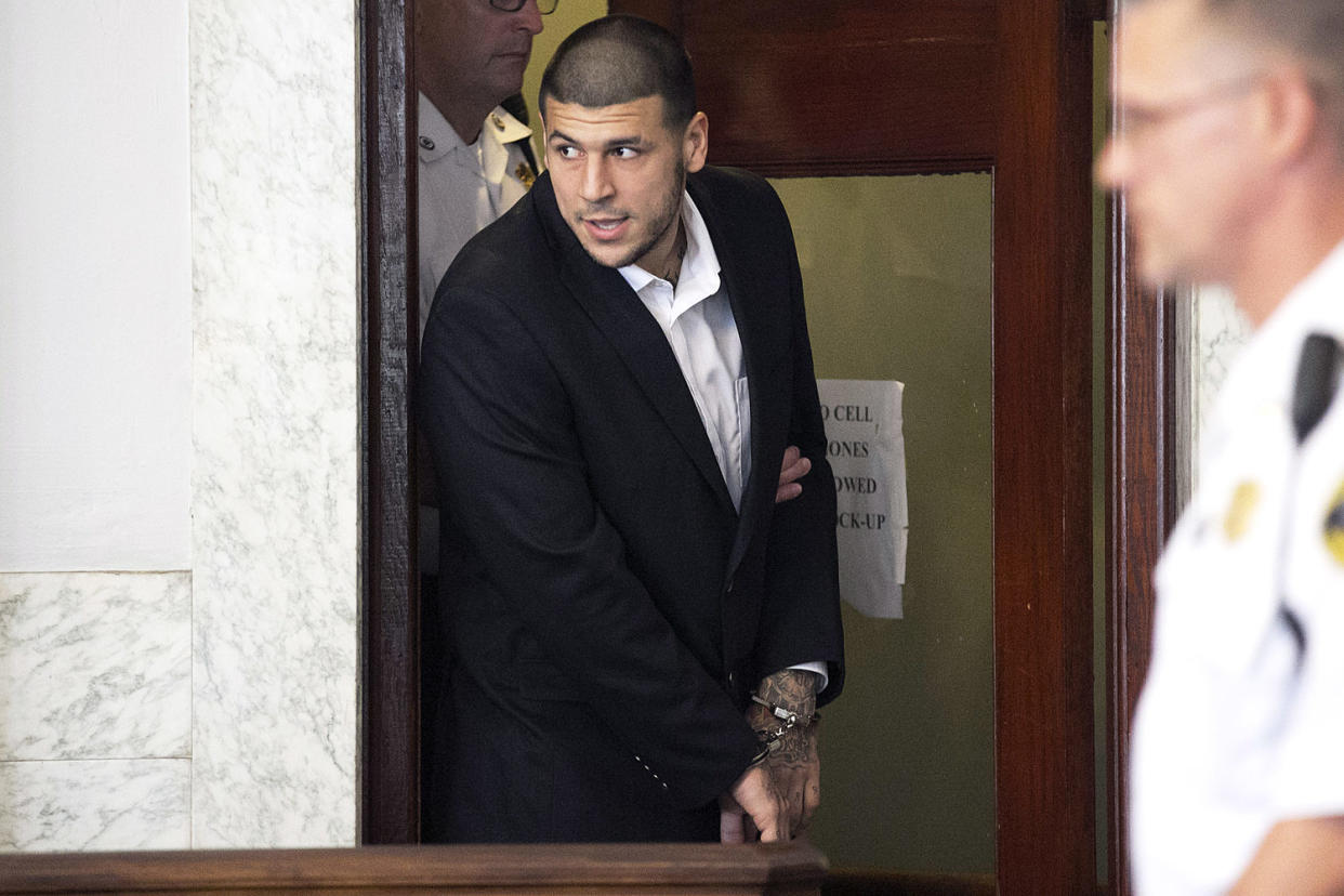 Aaron Hernandez enters the courtroom in handcuffs. (Yoon S. Byun/The Boston Globe/Getty Images)