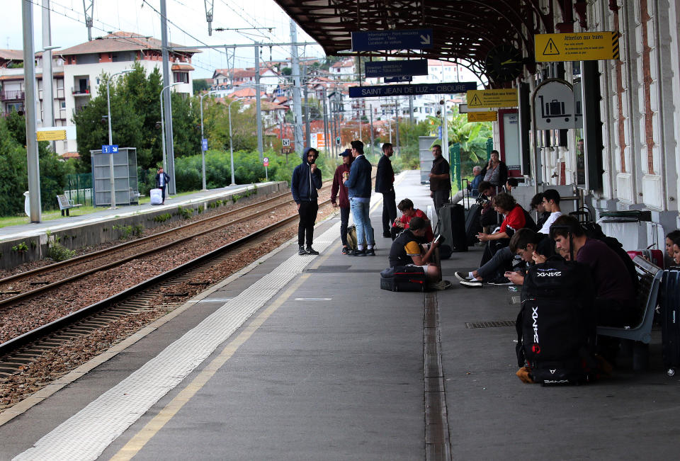 Travelers wait for trains on the platform of the station of Saint Jean de Luz, southwestern France, Friday, Oct.18, 2019. A wildcat strike is disrupting train travel around France, as railway workers demand better security after a recent accident. (AP Photo/Bob Edme)