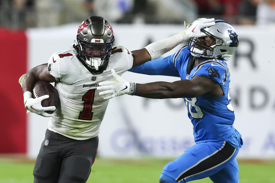 Tampa Bay Buccaneers running back Rachaad White pushes off Carolina Panthers linebacker Marquis Haynes Sr. during the second half of an NFL football game Sunday, Dec. 3, 2023, in Tampa, Fla. (AP Photo/Mark LoMoglio)