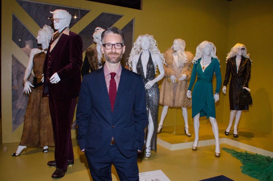 In this Saturday, Feb. 8, 2014 photo, costume designer Michael Wilkinson attends the 22nd annual Art of Motion Picture Costume Design Exhibit, in Los Angeles, Calif. Wilkinson's costumes for the film "American Hustle," are nominated for an Academy Award. The Fashion Institute of Design & Merchandising holds its free-to-the-public Art of Motion Picture Costume Design exhibit on view until April 26, 2014, featuring this year's five Oscar nominees: "American Hustle," "The Grandmaster," "The Great Gatsby," "The Invisible Woman" and "12 Years A Slave," in Los Angeles. (Photo by Tonya Wise/Invision/AP)