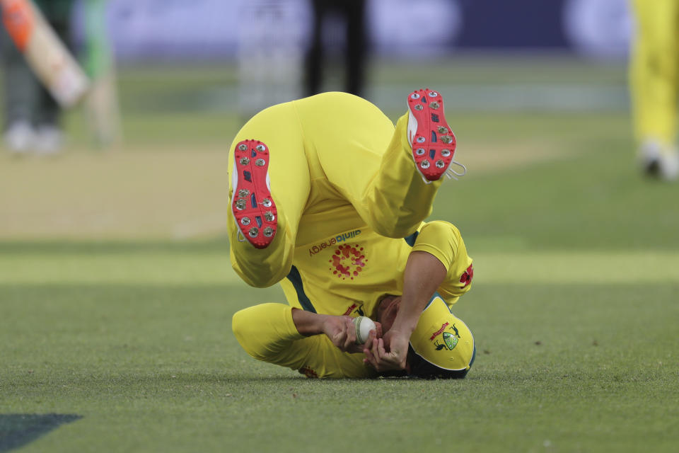 Australia's Aaron Finch tumbles after he caught a shot from South Africa's Heinrich Klaasen during their one-day international cricket match in Perth, Sunday, Nov. 4, 2018. (AP Photo/Trevor Collens)