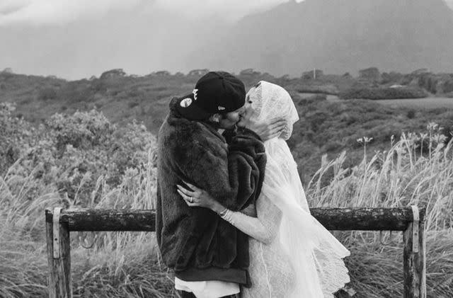 <p>Rory Kramer</p> Justin and Hailey Bieber share a kiss in vow renewal and pregnancy announcement post
