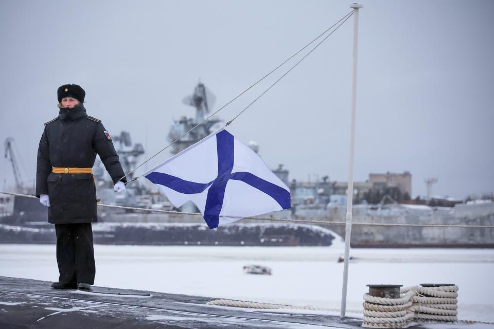 A Russian sailor stands on the deck of the newly-built nuclear submarine The Emperor Alexander III while Russian President Vladimir Putin during a flag-raising ceremony for newly-built nuclear submarines at the Sevmash shipyard in Severodvinsk in Russia's Archangelsk region, Monday, Dec. 11, 2023. The navy flag was raised on the Emperor Alexander III and the Krasnoyarsk submarines during Monday's ceremony. Putin has traveled to a northern shipyard to attend the commissioning of new nuclear submarines, a visit that showcases the country's nuclear might amid the fighting in Ukraine. (Mikhail Klimentyev, Sputnik, Kremlin Pool Photo via AP)