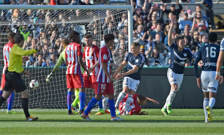 Melbourne Victory's Nicholas Ansell waves after scoring against Altetico Madrid during the friendly match in Geelong near Melbourne on July 31, 2016