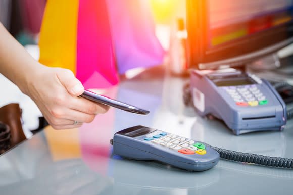 Customer pays at a store with a smartphone.