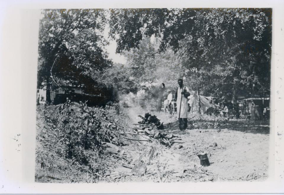 Barbecuing the meat at the Emancipation Day Celebration on June 19, 1900. The 1900 celebration was held in "East Woods" on East 24th St. near the home of the photographer.