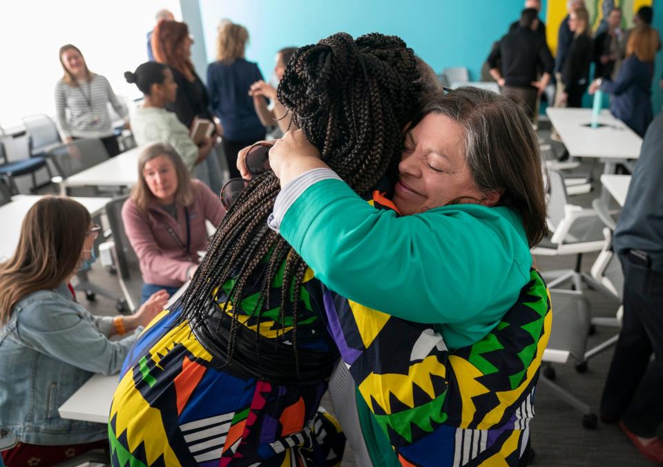Nicole Avery Nichols, left, was greeted with an enthusiastic hug from Detroit Free Press staff writer Tresa Baldas after Nichols was named the Detroit Free Press top editor on Wednesday, May 3, 2023 .
