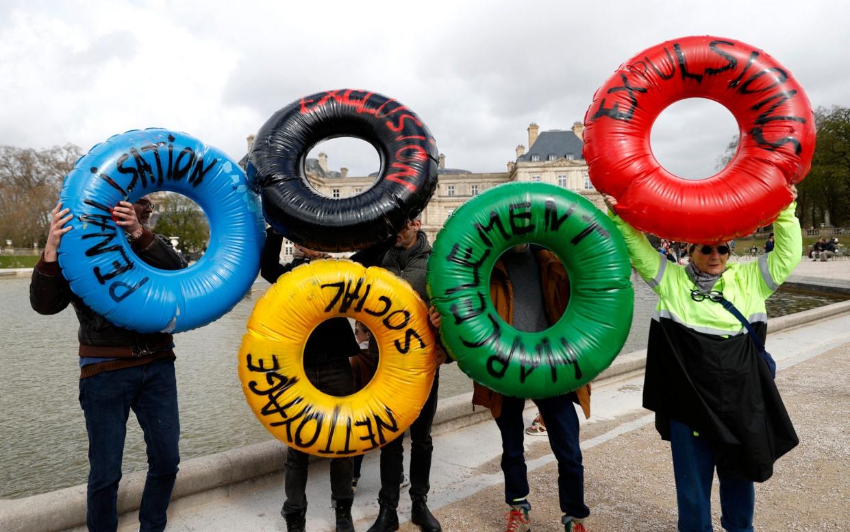 Anti-Olympics protesters with inflatables, in the colours of the Olympic rings in front of Luxembourg Palace, which houses the French Senate in Paris, France, March 24, 2024.