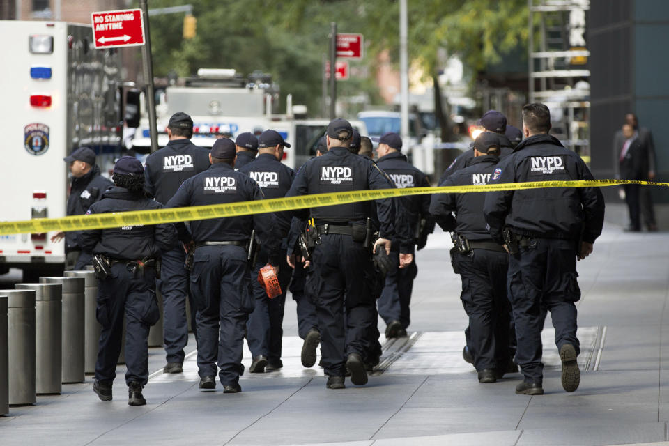 NYPD officers depart from the Time Warner Center area after a suspicious package that prompted an evacuation of CNN’s offices. Source: AP