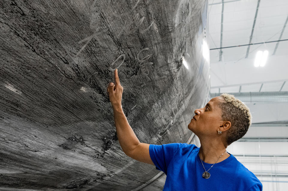 Dr. Sian Proctor signing the Falcon 9 reusable rocket booster that will launch the Inspiration4 crew into space. It has become a new tradition for SpaceX crews to sign their reusable vehicles.<span class="copyright">John Kraus—Inspiration4</span>