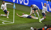 England's Harry Kane, on ground, celebrates with teammate's, Kyle Walker, left, Jordan Henderson and Phil Foden, right, after scoring his team's second goal during the Euro 2020 soccer championship semifinal between England and Denmark at Wembley stadium in London, Wednesday, July 7, 2021. (Justin Tallis/Pool Photo via AP)