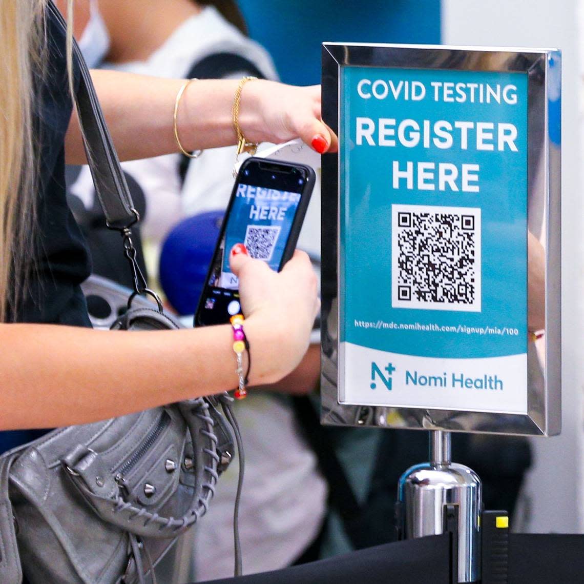 A woman attempts to register for a COVID-19 test at the Naomi Health COVID Testing Center located inside Concourse H at Miami International Airport in Miami, Florida, in January 2022.