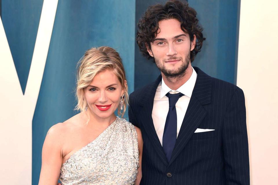 <p>PA Images/Alamy</p> Sienna Miller and Oli Green