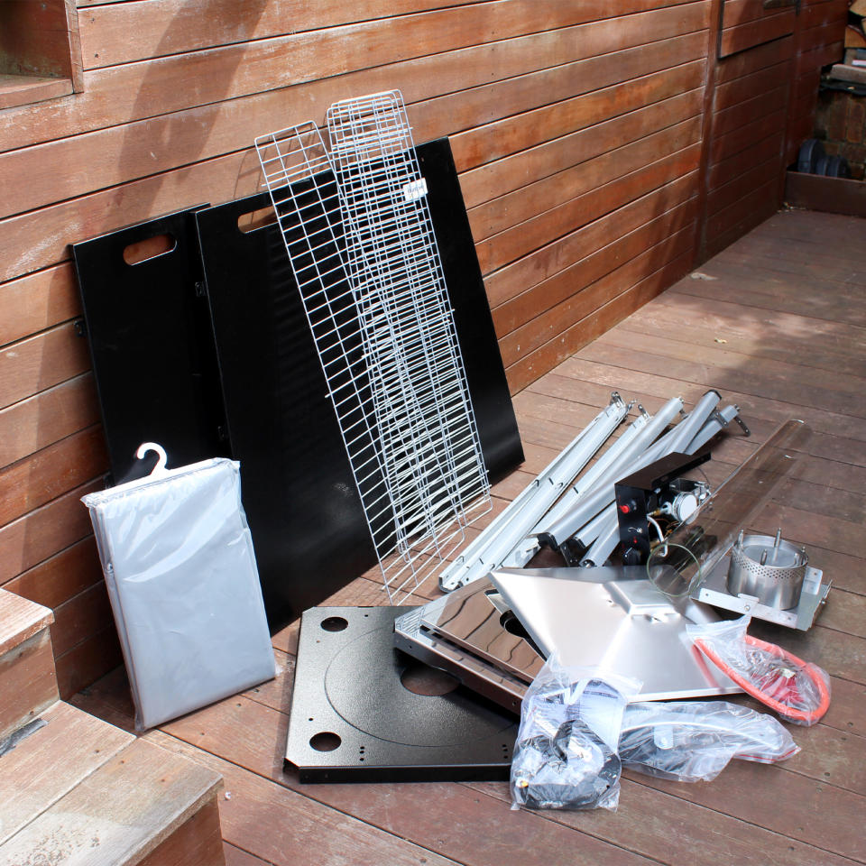 The Outsunny 11.2kw Pyramid Gas Patio Heater being unboxed and tested on a wooden deck