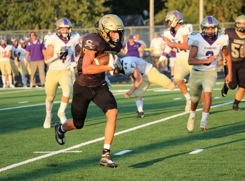 Corunna's Tarick Bower heads toward the end zone with the second of his three touchdowns in a 36-13 victory over Fowlerville on Friday, Aug. 26, 2022.