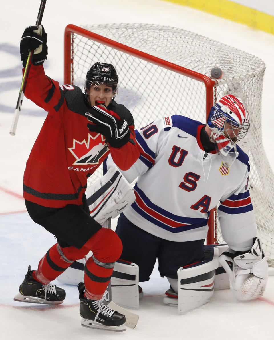 Canada's Dylan Cozens, left, celebrates his sides second goal scored past goaltender Spencer Knight of the US, right, during the U20 Ice Hockey Worlds match between Canada and the United States in Ostrava, Czech Republic, Thursday, Dec. 26, 2019. (AP Photo/Petr David Josek)