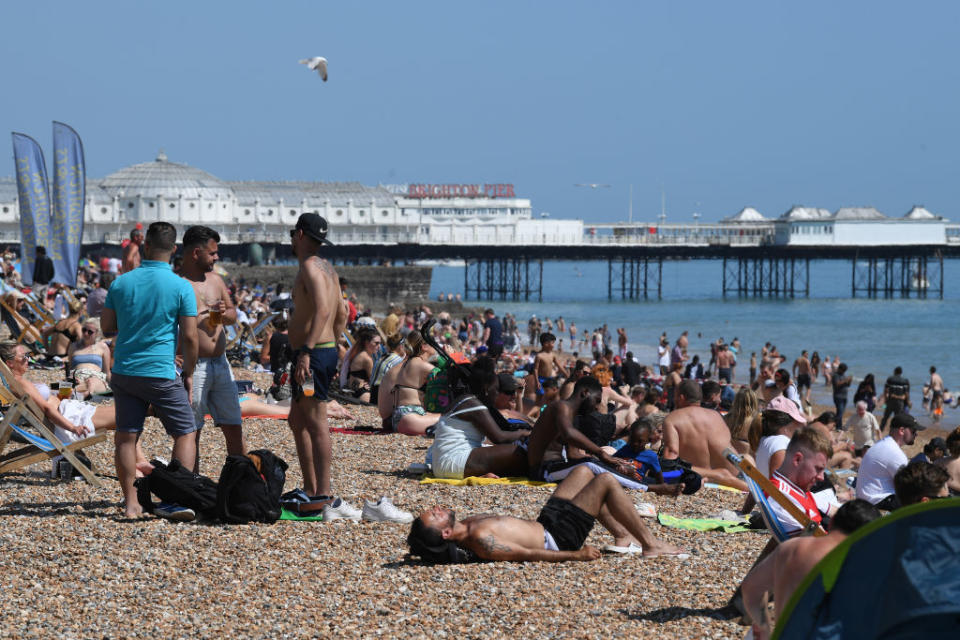 Friends chat on Brighton beach on May 25. Source: Getty Images