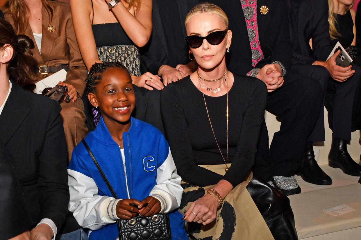 Charlize Theron (R) and August sat front row at Dior's show Monday night.