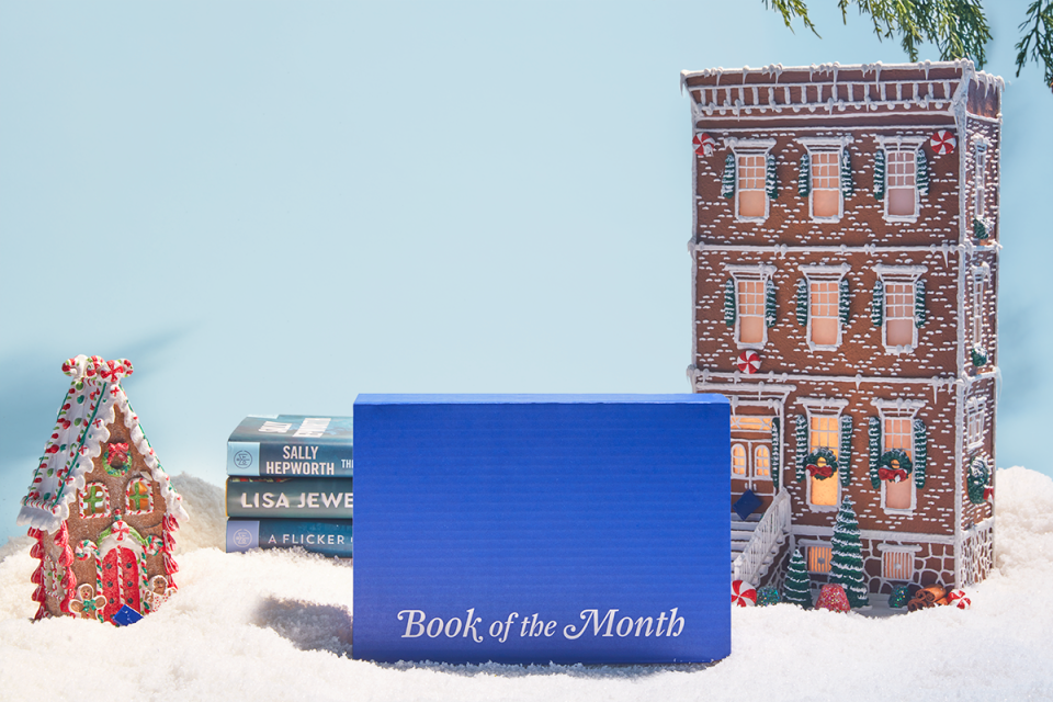 A blue Book of the Month box in front of a winter scene