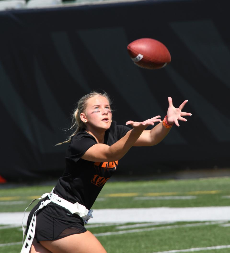 This athlete looks in a long pass reception at the girls flag football kickoff jamboree sponsored by USA Football and the Cincinnati Bengals at Paycor Stadium, Sept. 30, 2023.