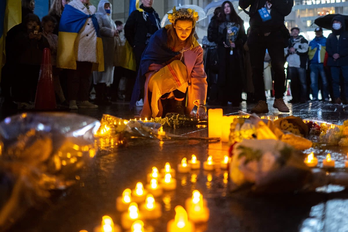 People take part in a candlelight vigil outside UN University to mark the one year anniversary of the Russian invasion of Ukraine, in Tokyo (AFP/Getty)