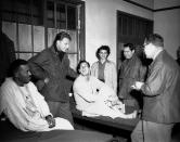 <p>Billy Graham, second from left, visits service personnel at the 21st Evacuation Hospital in Pusan, Korea, on Dec. 21, 1952, during a tour of U.N. bases in the Far East. (Photo: AP) </p>