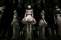 A dress from the Alexander McQueen It's Only a Game, spring/summer 2005 collection is reflected in mirrors in the Alexander McQueen: Savage Beauty exhibition at the V&A in London, March 12, 2015. REUTERS/Suzanne Plunkett