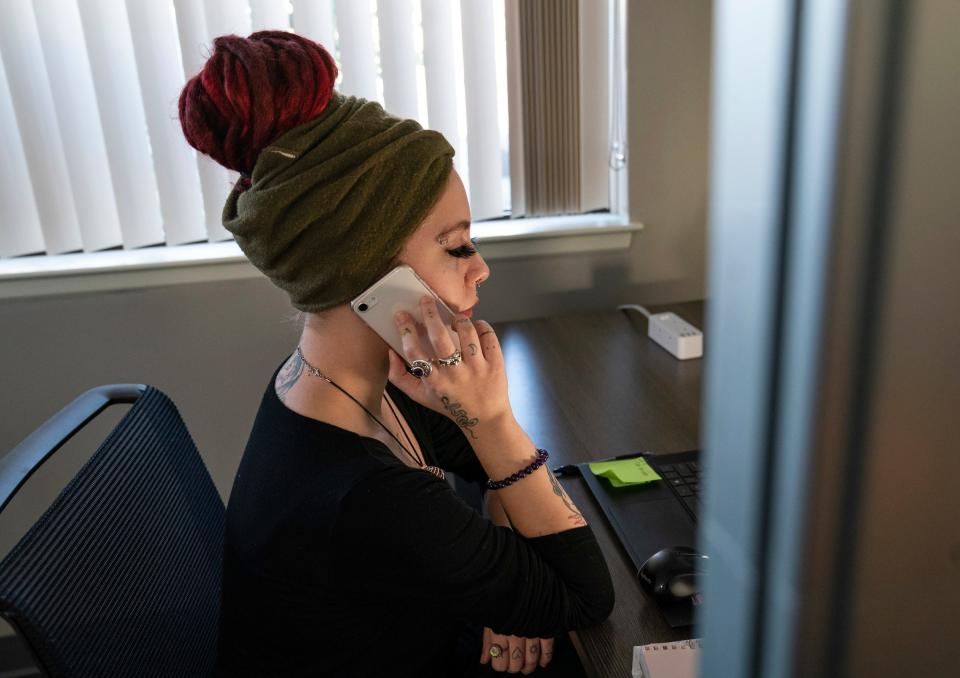 Hope not Handcuffs volunteer Emily Taube, 23, works the call center for those seeking help with substance use disorder at the Clinton Township offices on Nov. 22, 2022. They are known as 'angels' for their volunteer work.