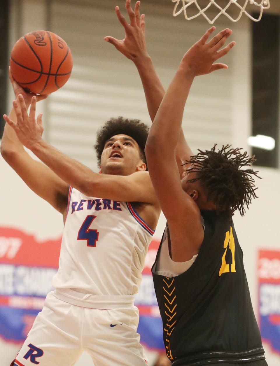 Revere's Carson Banks shoots over Cuyahoga Falls' Le'Aaron Austin at Revere High School, Friday. Dec. 10, 2021.