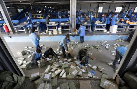 Employees work at a sorting centre of Zhongtong (ZTO) Express ahead of the Singles Day shopping festival, Chaoyang District, Beijing, November 8, 2015. REUTERS/Jason Lee -