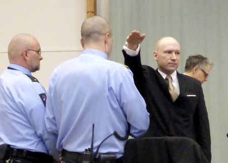 FILE PHOTO: Mass killer Anders Behring Breivik raises his arm in a Nazi salute as he enters the court room in Skien prison, Norway March 15, 2016. REUTERS/Gwladys Fouche/File Photo