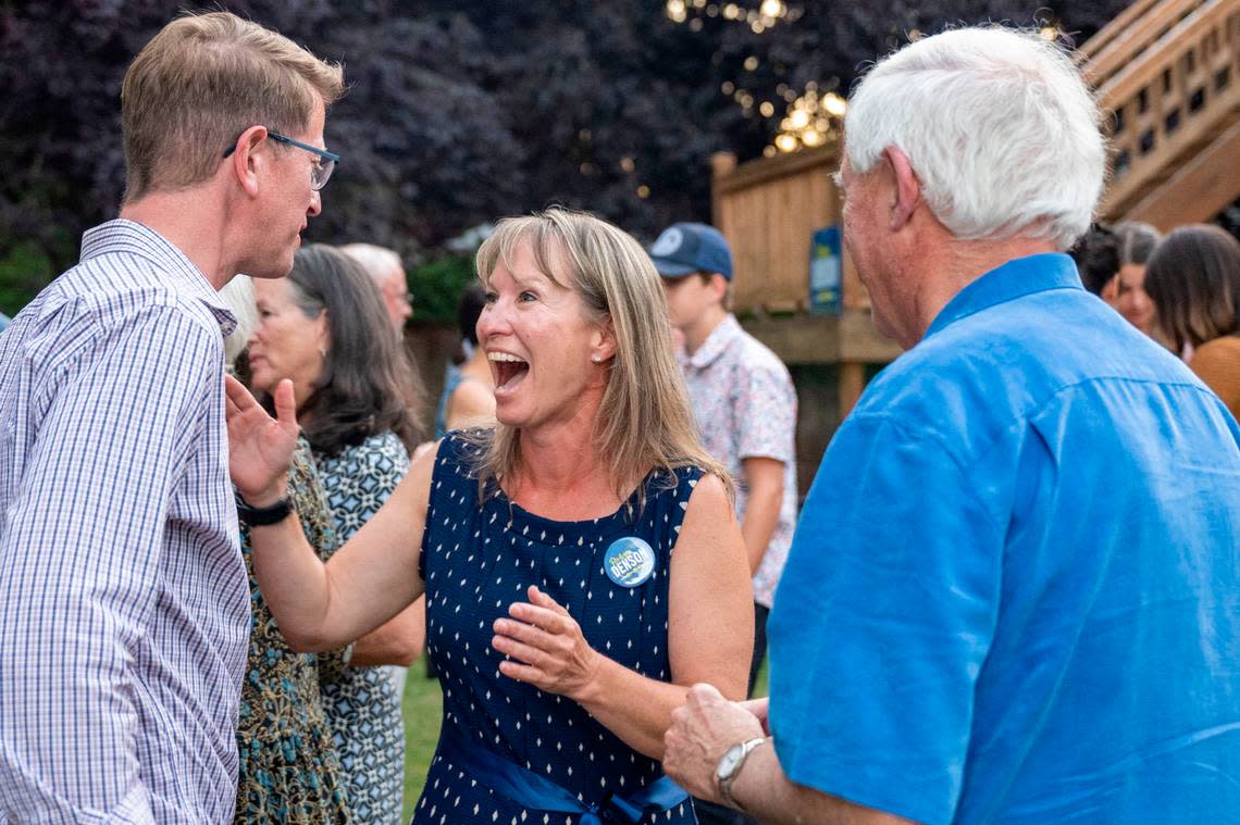 Democrat Robyn Denson (center) celebrates with U.S. Rep. Derek Kilmer, D-Wash. (left), after primary results were announced at an election party in Gig Harbor, Wash. on Tuesday, Aug. 2, 2022. Initial results on Tuesday evening had Denson capturing nearly 59-percent of the vote for the Pierce County Council, District 7 seat.