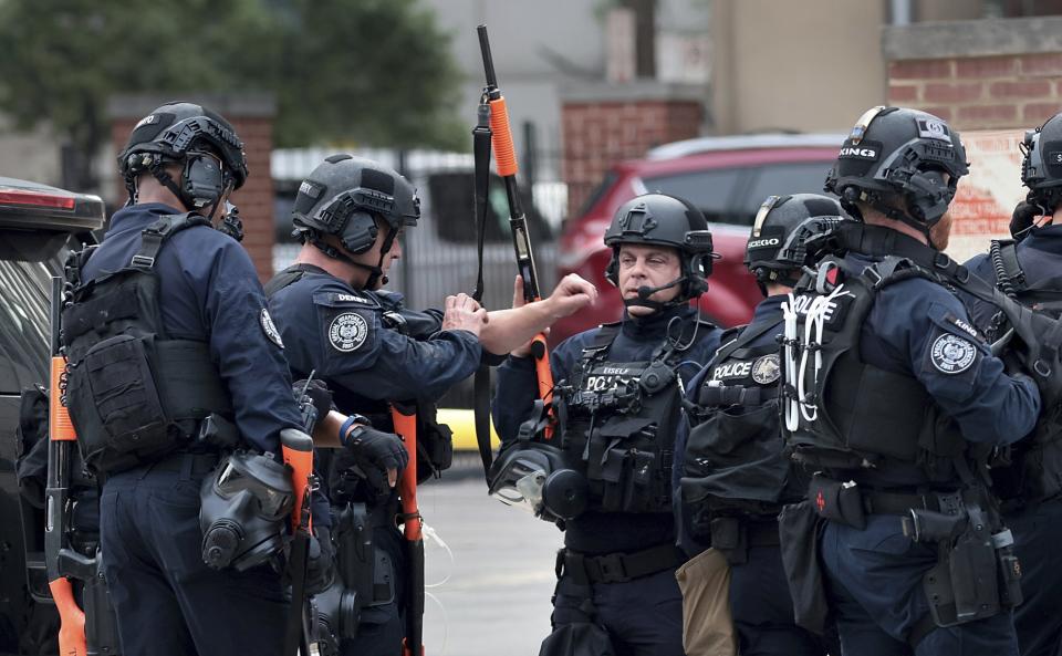 The St. Louis police SWAT team gathers in front of the city jail in downtown St. Louis, known as the City Justice Center, after a guard was reportedly taken hostage on Tuesday, Aug. 22, 2023. (Robert Cohen/St. Louis Post-Dispatch via AP)